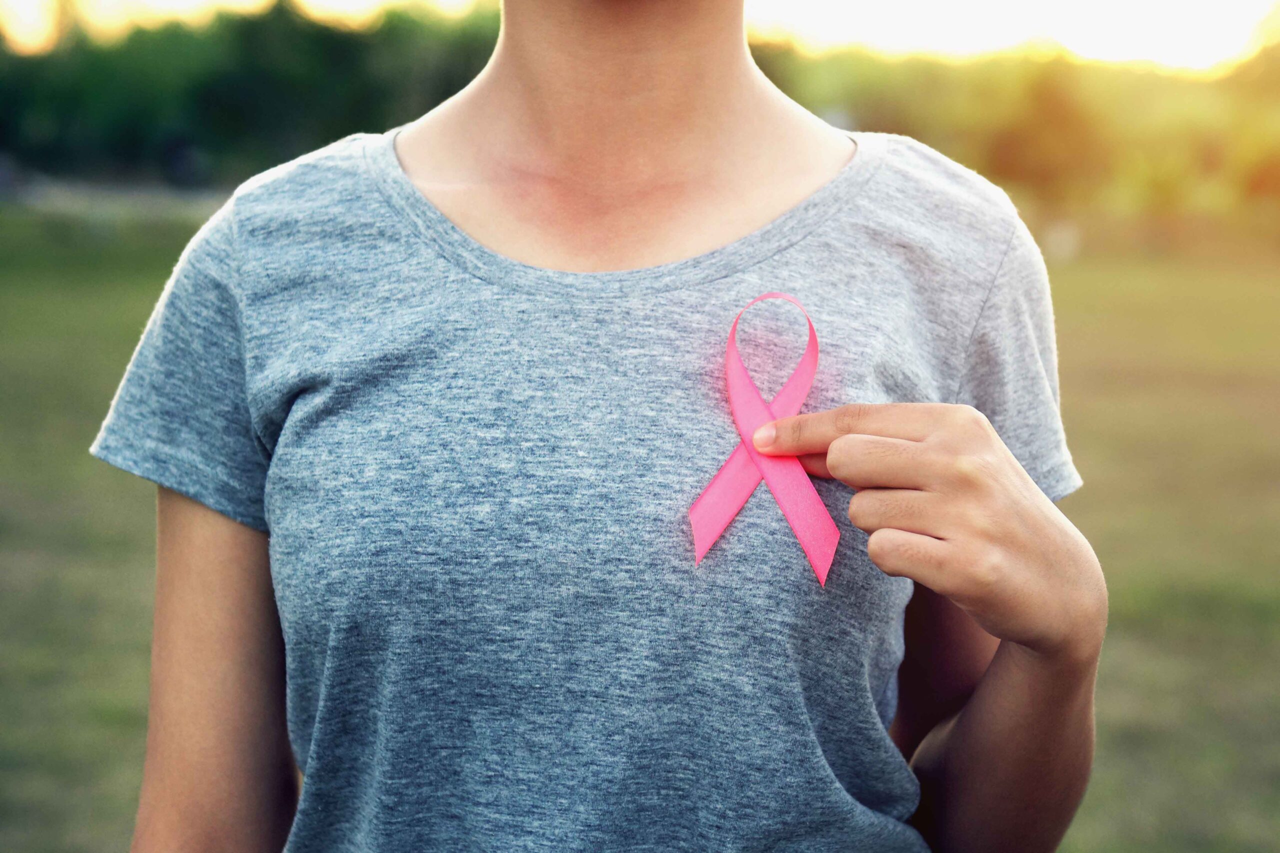 woman holding pink ribbon breast cancer awareness. concept healt